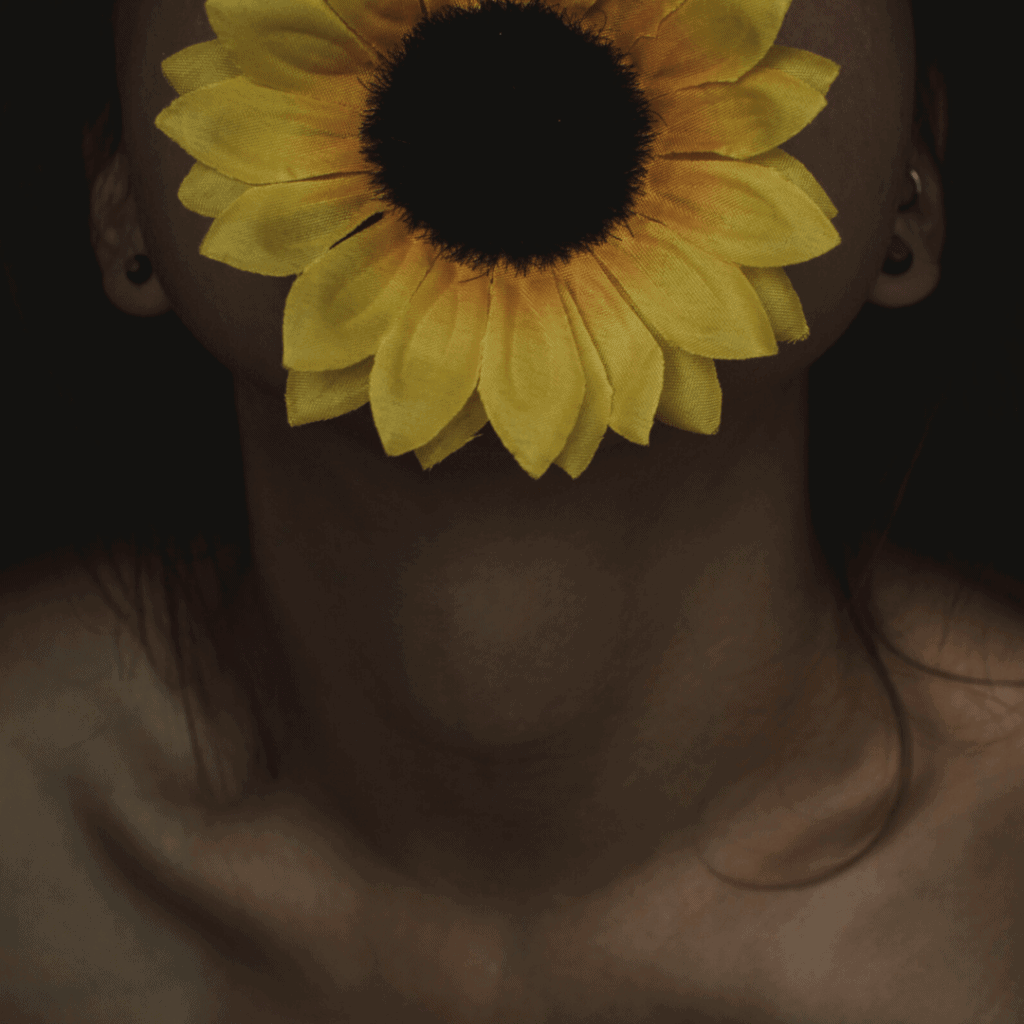 woman with sunflower on mouth