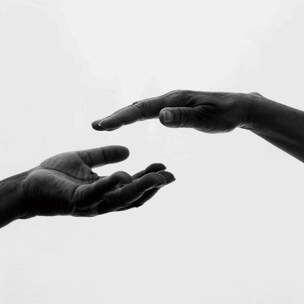 two hands trying to reach each other
