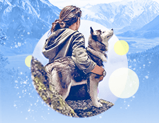 an image of a white woman woman wearing a hoodie while holding a dog with mountains in the background