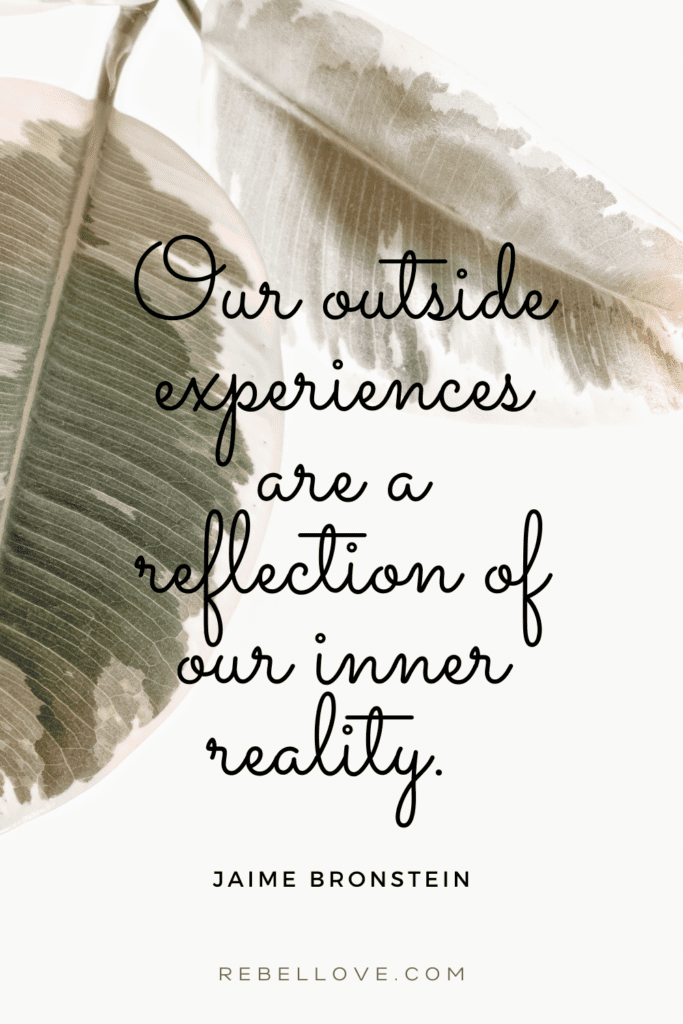 a Pinterest pin quote for the Rebel Love Podcast Episode 24, How to Manifest An Energetically-Aligned Relationship that says "Our outside experiences are a reflection of our inner reality" a quote mentioned by Jaime Bronstein. Dried leaves in the background.
