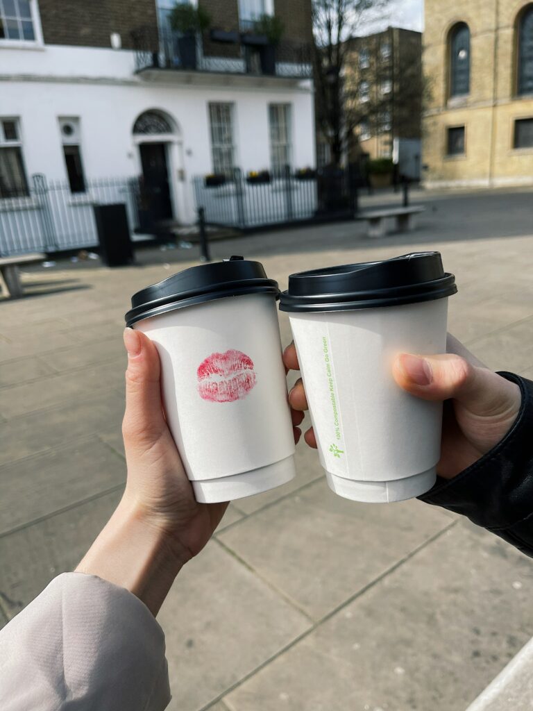 a photo of coffee cups, one with lipstick mark on it