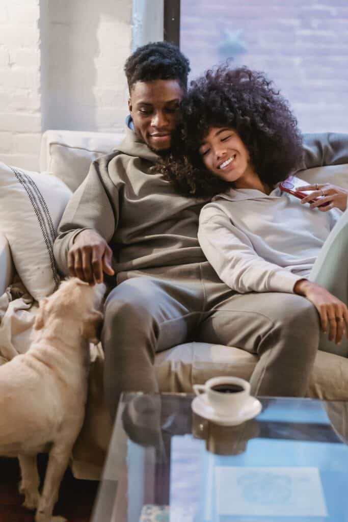 diverse couple enjoying their time together and their dog in a couch