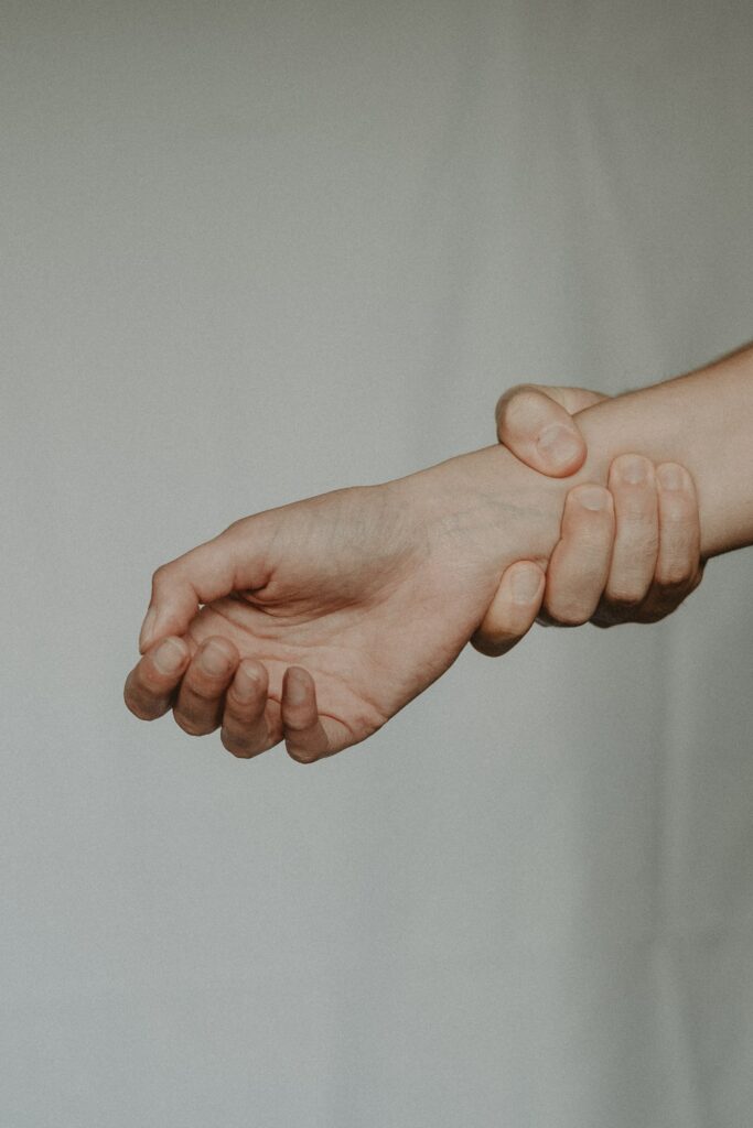 a photo of a hand being held strongly by another hand to convey control