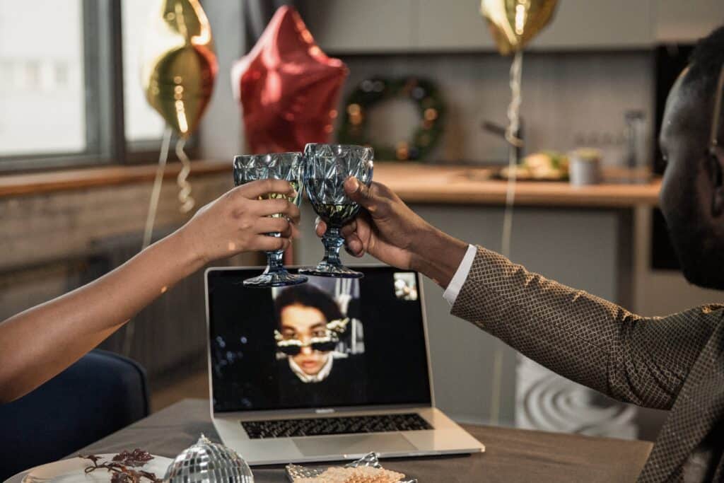 a photo of three friends virtually celebrating the holidays together via virtual